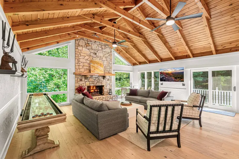 East Great Room — stone fireplace and waterfall views