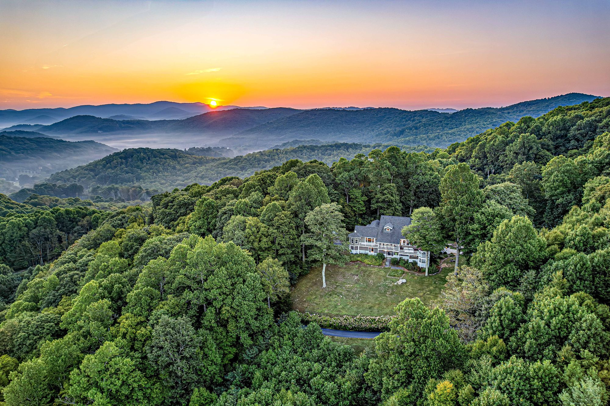 Aerial view of Hemingway Estates at sunrise on 18 private acres in Banner Elk